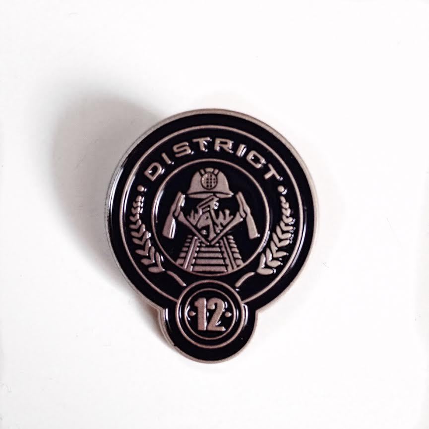 The Hunger Games Movie District 12 Logo Metal Enamel Die-Cut Pin NEW UNUSED 