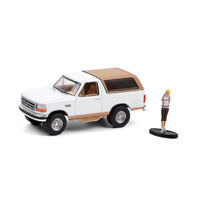 Greenlight 1:64 The Hobby Shop Series 10  - 1996 Ford Bronco Eddie Bauer with Backpacker in Oxford White and Light Saddle